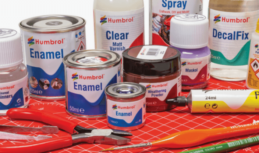 Humbrol products and paint brushes on a cutting mat