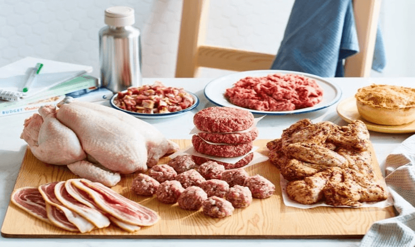 A selection of raw meats and poultry on a table