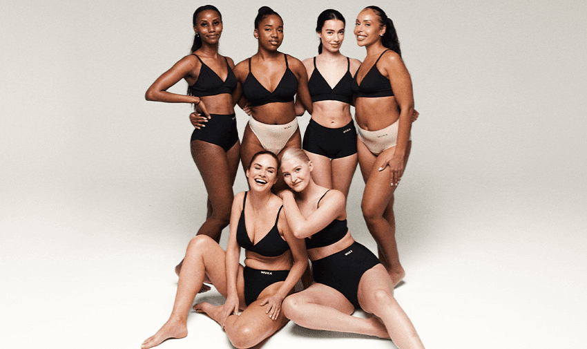 A group of diverse women smiling and posing in WUKA lingerie, promoting sustainable and inclusive fashion. 