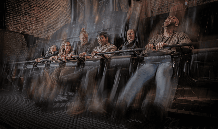 Guests on a thrilling drop ride inside the London Dungeon, capturing their excitement and fear.