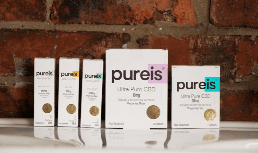 A selection of Pureis Ultra Pure CBD products displayed against a rustic brick wall, highlighting a variety of strengths and formats. Discover exclusive Pureis offers through Purpl's disabled discounts platform.