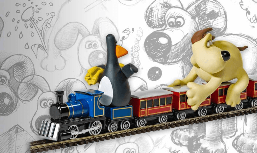 A toy train featuring a dog and a penguin