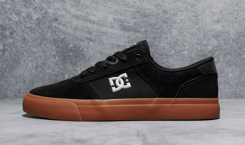 A single black DC trainer with a brown sole