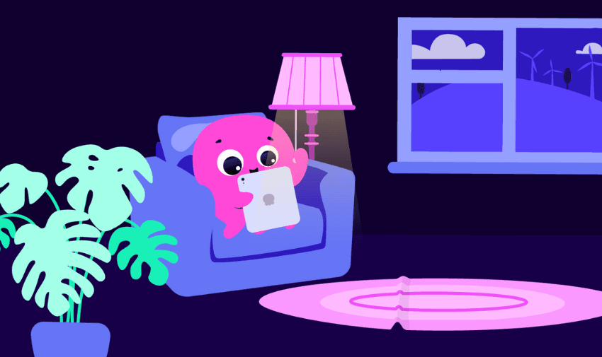 Octopus Energy’s pink octopus character sitting in a cosy armchair using a tablet by a glowing lamp, with a view of wind turbines outside, showcasing smart energy management and highlighting Purpl's online discounts for disabled people in the UK.