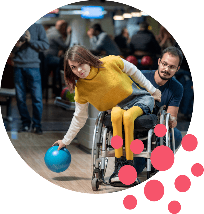 Disabled woman in a wheelchair bowling.