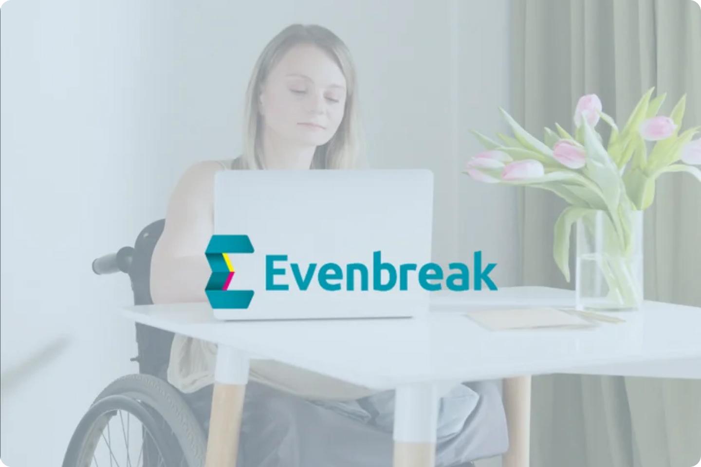 A person in a wheelchair sits at a desk using a laptop. A bouquet of tulips in a glass vase is on the desk. The logo and text "Evenbreak" are overlaid on the image.