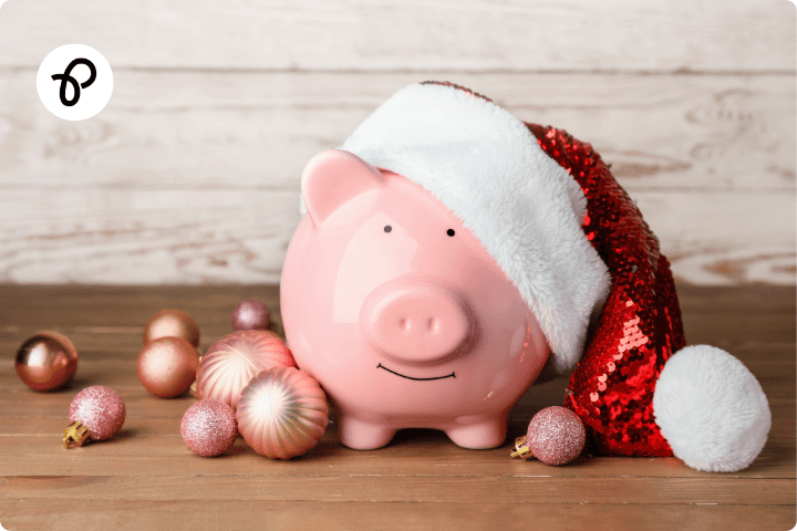 A piggy bank wearing a Santa hat with baubles for a blog about managing money at christmas for disabled people