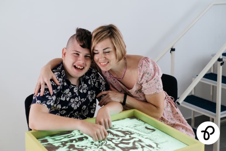 Unpaid carer supporting a young person with additional needs showing everyday life for carers affected by Carer’s Allowance issues and financial pressure.