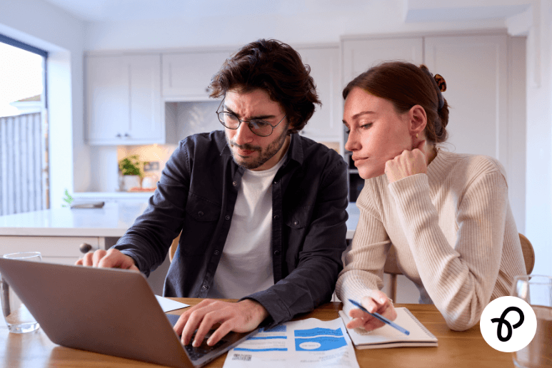 Disabled couple reviewing bills and budgeting on a laptop at home, showing debt support and financial help for people with disabilities