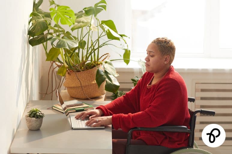 Wheelchair user applying online for disability grants in the UK to help with extra costs of living with a disability and long term health conditions using Purpl discounts.