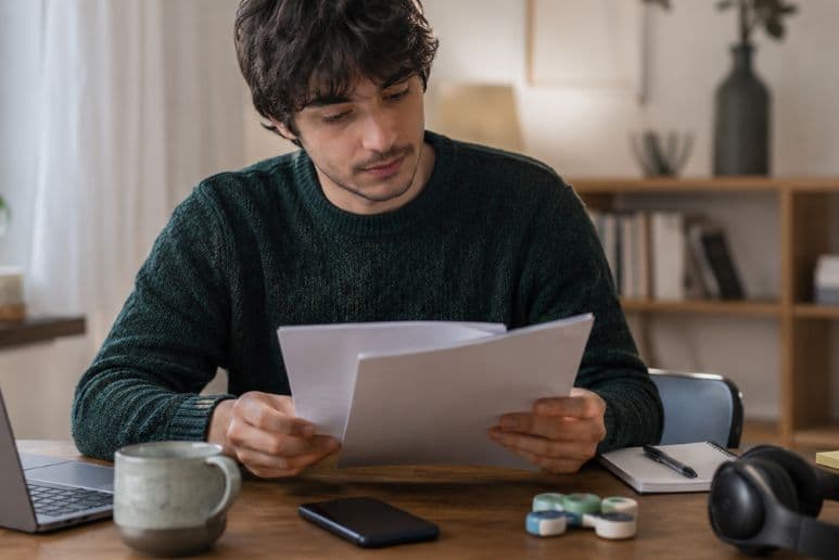 Person waiting with paperwork and sensory tools while seeking autism and ADHD assessment support, with disabilities and long-term health conditions supported by Purpl discounts.