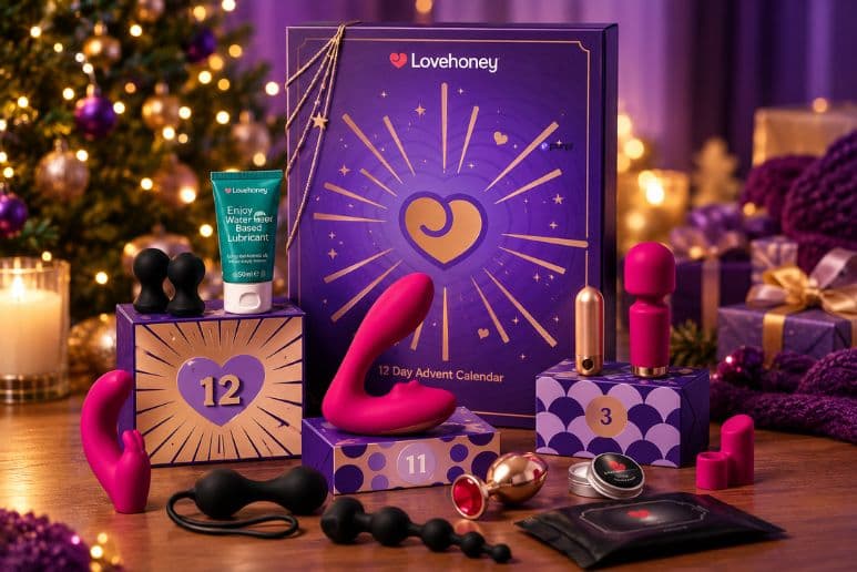 Lovehoney Indulge Advent Calendar surrounded by adult toys and accessories in a festive Christmas setting, promoting Purpl's giveaway for disabled members.